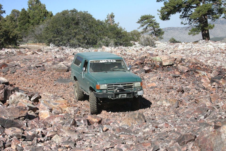 Green 1991 Ford Bronco on rocky trail