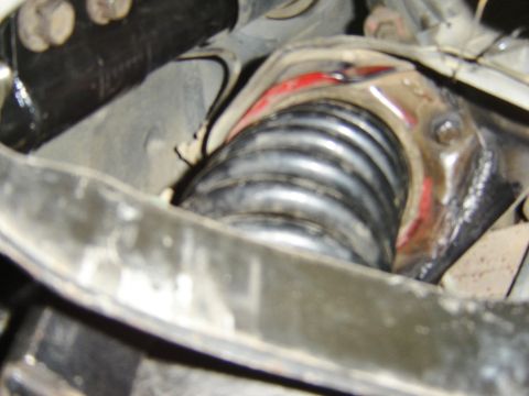 1987 Lincoln Mark VII - Close-up view of a vehicle's suspension spring and its mounting hardware, showing some red paint markings.