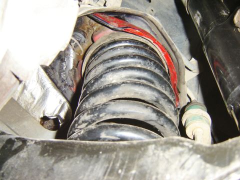 1987 Lincoln Mark VII - This image shows a close-up view of a vehicle's suspension system, focusing on the coil spring.