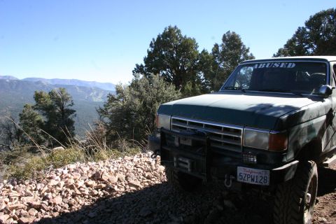 1991 Ford Bronco - This 1991 Ford Bronco is parked on a mountain trail with a scenic view.