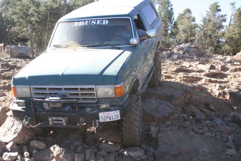 1991 Ford Bronco - This Ford Bronco is navigating a rocky off-road trail, demonstrating its capability on challenging terrain.