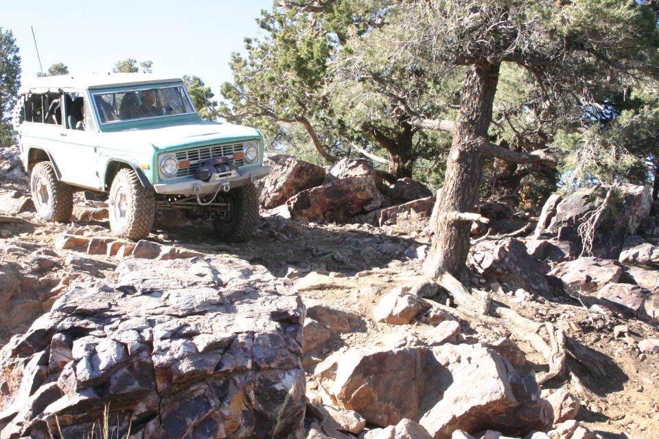 Green SUV with winch on rocky trail