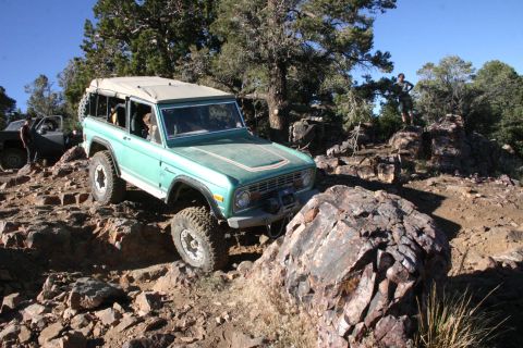 1991 Ford Bronco - This classic Ford Bronco, likely from the early to mid-1970s, tackles a challenging off-road course with another vehicle visible in the bac…