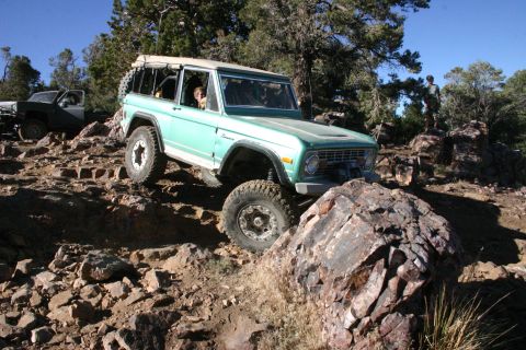 1991 Ford Bronco - Off-road adventure in a classic Ford Bronco navigating a challenging rocky trail.
