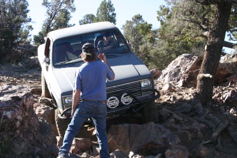 1991 Ford Bronco - This pickup truck, likely from the 1980s, is shown tackling a challenging off-road course.