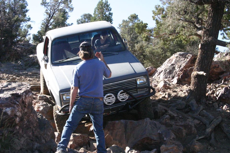 Gray pickup truck with Hella lights navigating rocky terrain