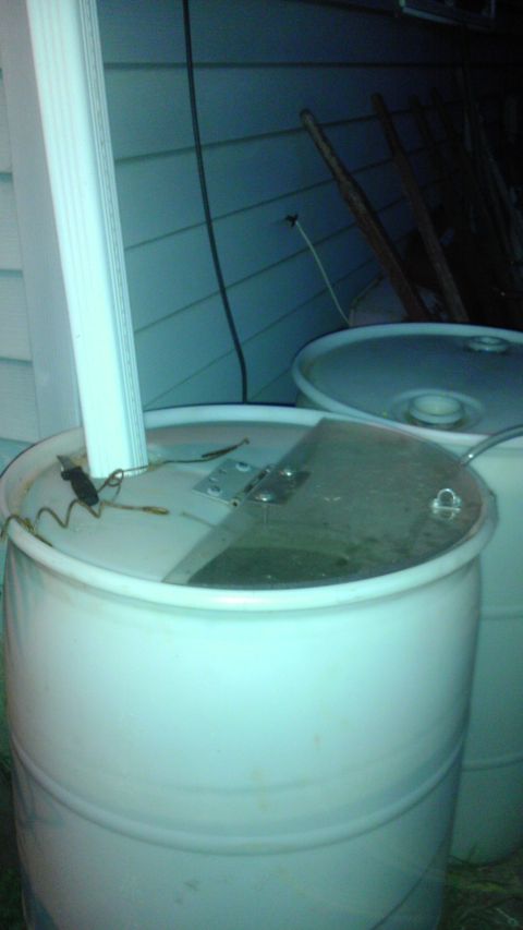 1989 Ford Bronco - Two white plastic barrels are visible, one with its lid open, revealing a ruler and some wires.