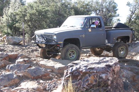 1991 Ford Bronco - This modified pickup truck navigates a rocky, off-road trail.