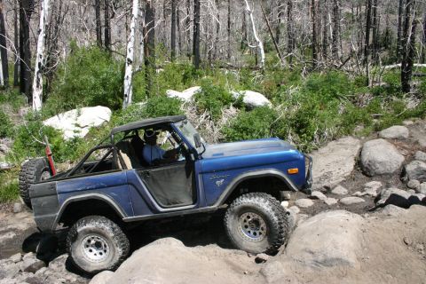 1991 Ford Bronco - This first-generation Ford Bronco is shown navigating a challenging rocky trail.