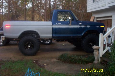 1979 Ford F-150 - This lifted 1979 Ford F-150 pickup truck is shown in a side profile, a two-tone paint scheme with a blue cab and a grey bed.