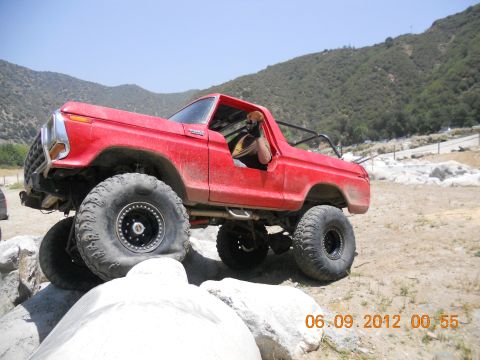 1986 Ford Bronco - Modified 1978 Ford Bronco navigating a rocky obstacle course on a sunny day.