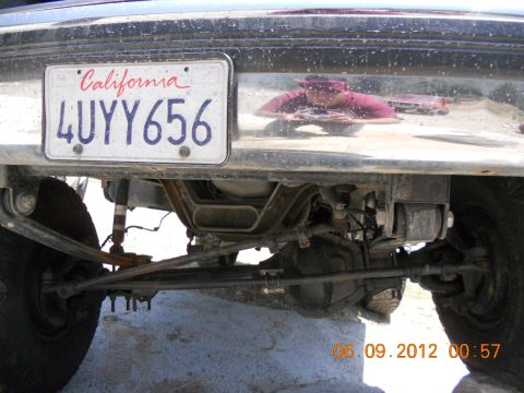 1986 Ford Bronco - Close-up view of the rear suspension and bumper, including a California license plate.