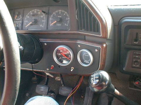 1990 Ford Bronco - Interior view of a 1990 Ford Bronco, showing the dashboard with gauges and a manual transmission shifter.