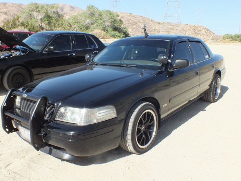 2003 Ford Crown Victoria - Murdered-out Crown Victoria with grille guard and dark wheels at the meetup