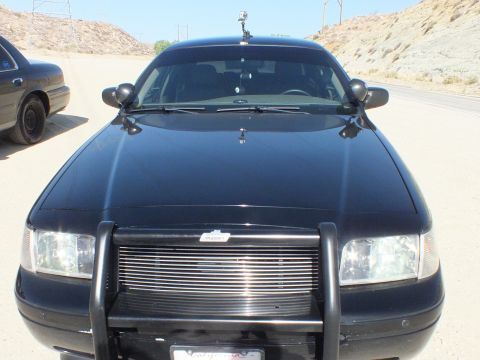 2003 Ford Crown Victoria - Head-on look at a black Crown Victoria with grille guard and billet grille