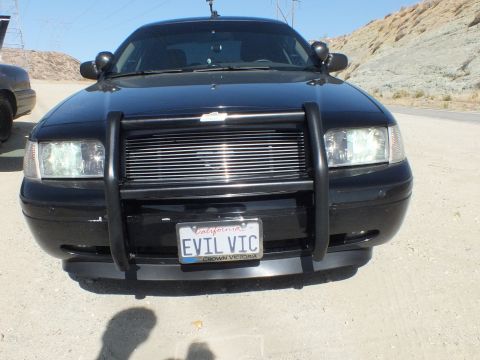 2003 Ford Crown Victoria - Black Crown Victoria wearing an EVIL VIC California plate and billet grille