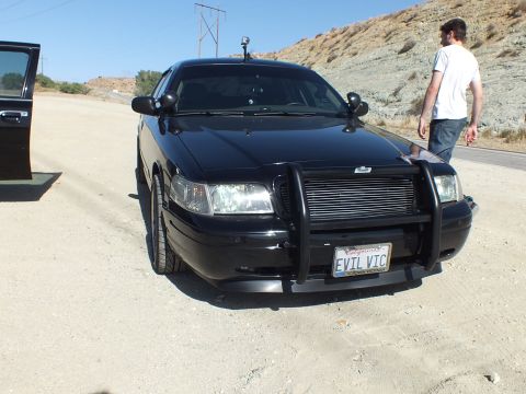 2003 Ford Crown Victoria - EVIL VIC Crown Victoria with grille guard as a man walks past on the roadside