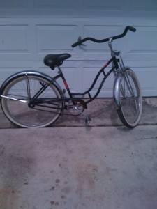 1953 Ford Mainline - A black cruiser bicycle is shown parked in front of a garage door.