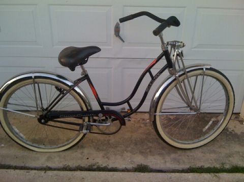 1953 Ford Mainline - This bicycle has a black frame, chrome fenders, and whitewall tires. The text 'Classic Cruiser' is visible on the chain guard.