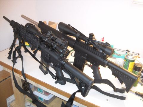 2012 Ford Mustang - Two rifles are displayed on a table with various cleaning supplies in the background.