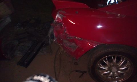 1991 Toyota MR2 - The rear of a red sports car shows significant damage to the bodywork and fender.