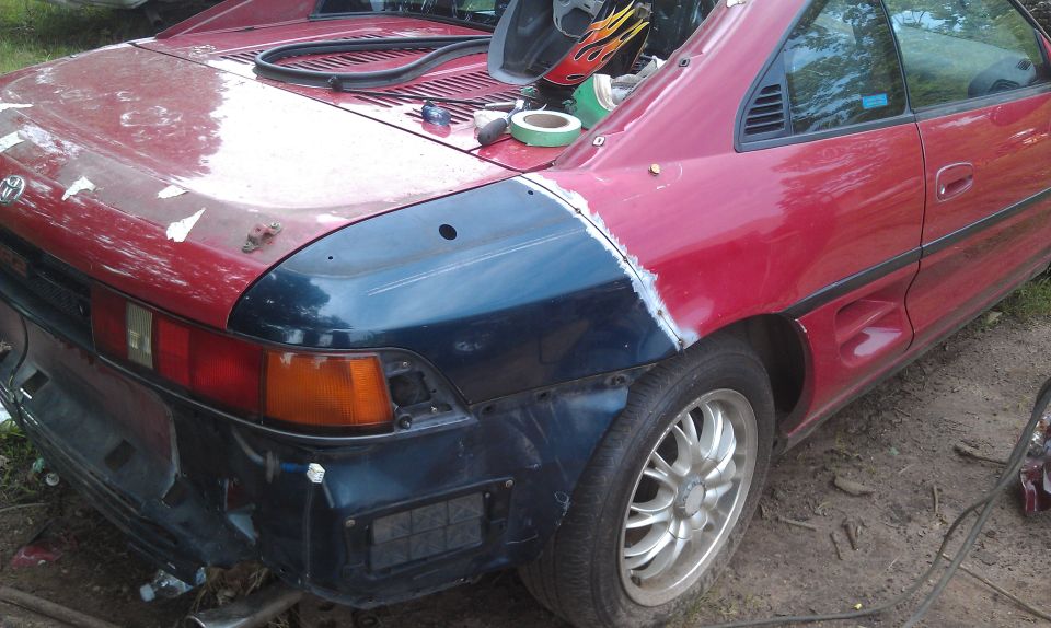 1991 Toyota MR2 rear quarter panel repair, red body with dark blue primer on fender