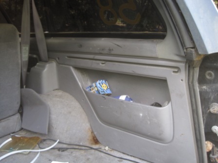 1993 Ford Bronco - The interior storage compartment of a vehicle is shown, with some items placed inside.