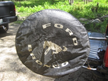 1993 Ford Bronco - Spare tire cover for a Ford Bronco, showing the brand name and a horse emblem.