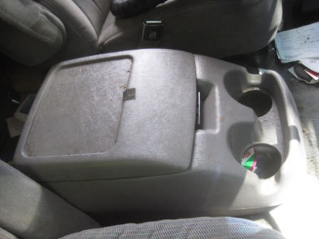 1993 Ford Bronco - Interior view of a gray plastic center console with a storage compartment and cup holders.