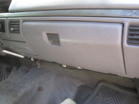 1993 Ford Bronco - Interior view of a vehicle's glove box and dashboard area. The registry claims it is a 1993 Ford Bronco, but this is not verifiable from th…
