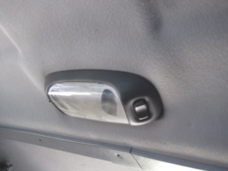 1993 Ford Bronco - Close-up of a vehicle's interior dome light assembly.