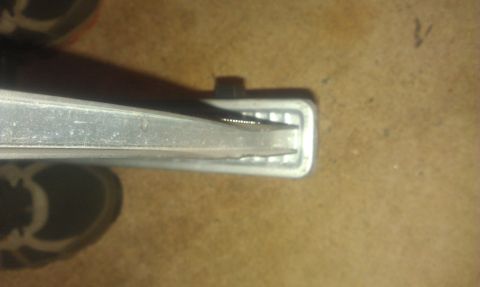 1991 Ford Festiva - This is a close-up view of a car door handle component.