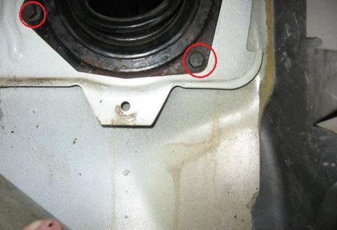 1992 Ford Bronco - Close-up view of a firewall boot and surrounding metalwork, with bolts circled in red.