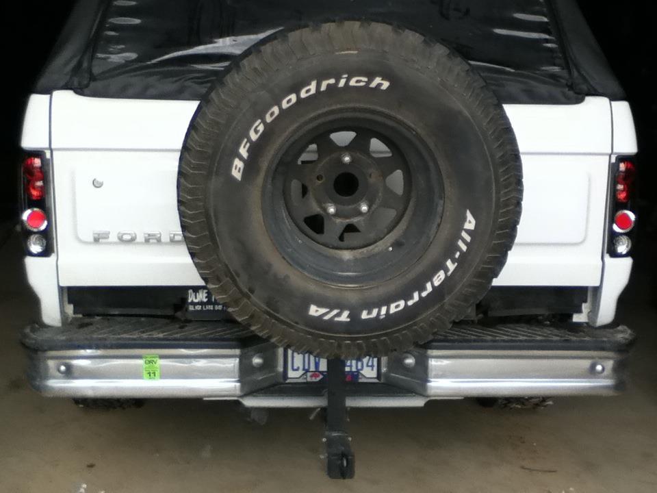 White 1993 Ford Bronco rear view with spare tire, chrome bumper, and license plate