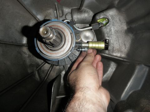 1961 International Scout 800 - Close-up of clutch release bearing and slave cylinder assembly being adjusted.