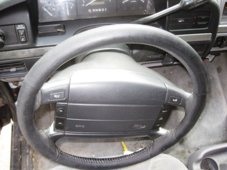1993 Ford Bronco - The interior of a 1993 Ford Bronco is visible, focusing on the steering wheel and instrument cluster.