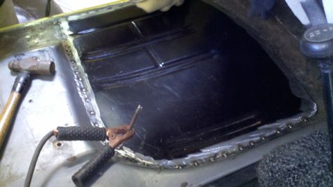 1978 Ford Bronco - Repairing rust damage on a vehicle's floor pan using welding techniques.