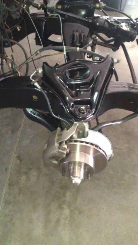 1973 Chevrolet Camaro - Close-up of a vehicle's front suspension and brake components during restoration or repair.