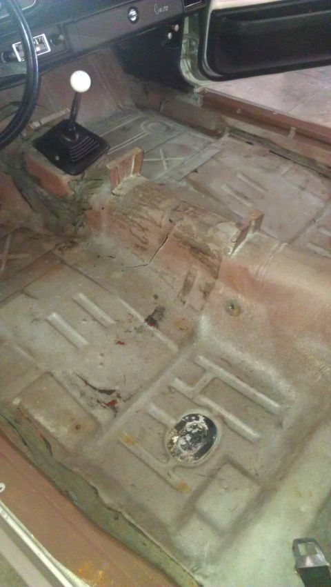1973 Chevrolet Camaro - The interior of a 1973 Chevrolet Camaro, a manual transmission shifter and a worn floor pan.