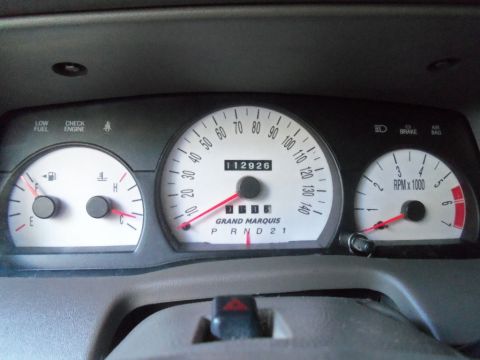 2000 Mercury Grand Marquis - The dashboard of a 2000 Mercury Grand Marquis displays the vehicle's speed, RPM, fuel level, and mileage.