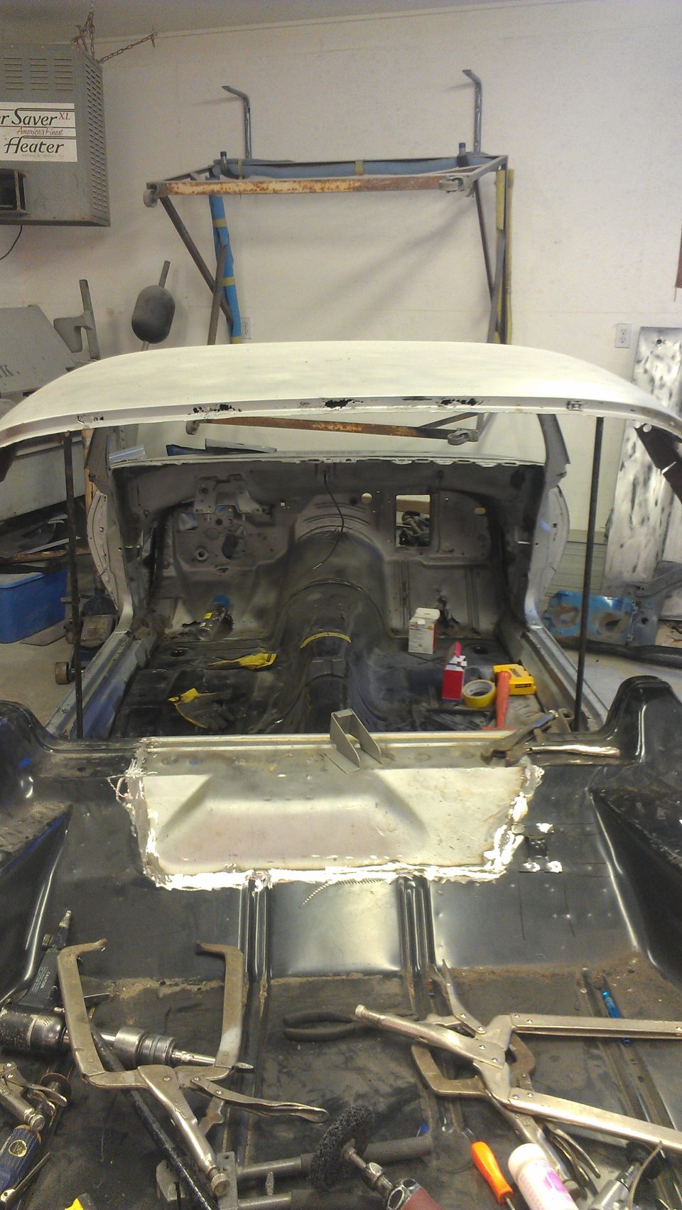 1970 Chevrolet Camaro interior stripped down for bodywork, showing floor pan and dashboard area