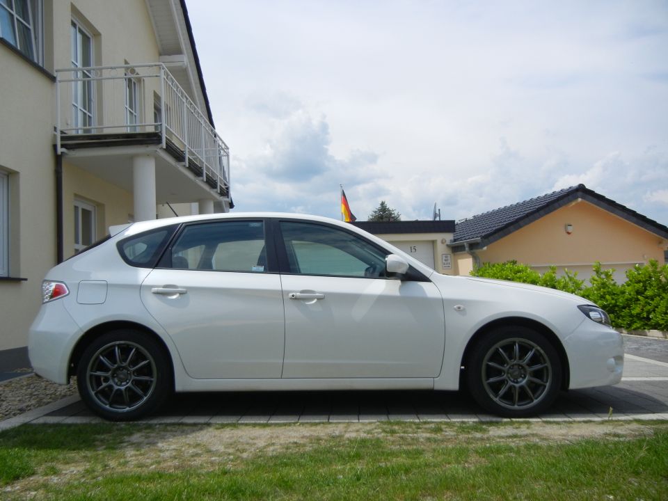 White 2008 Subaru Impreza hatchback, side view