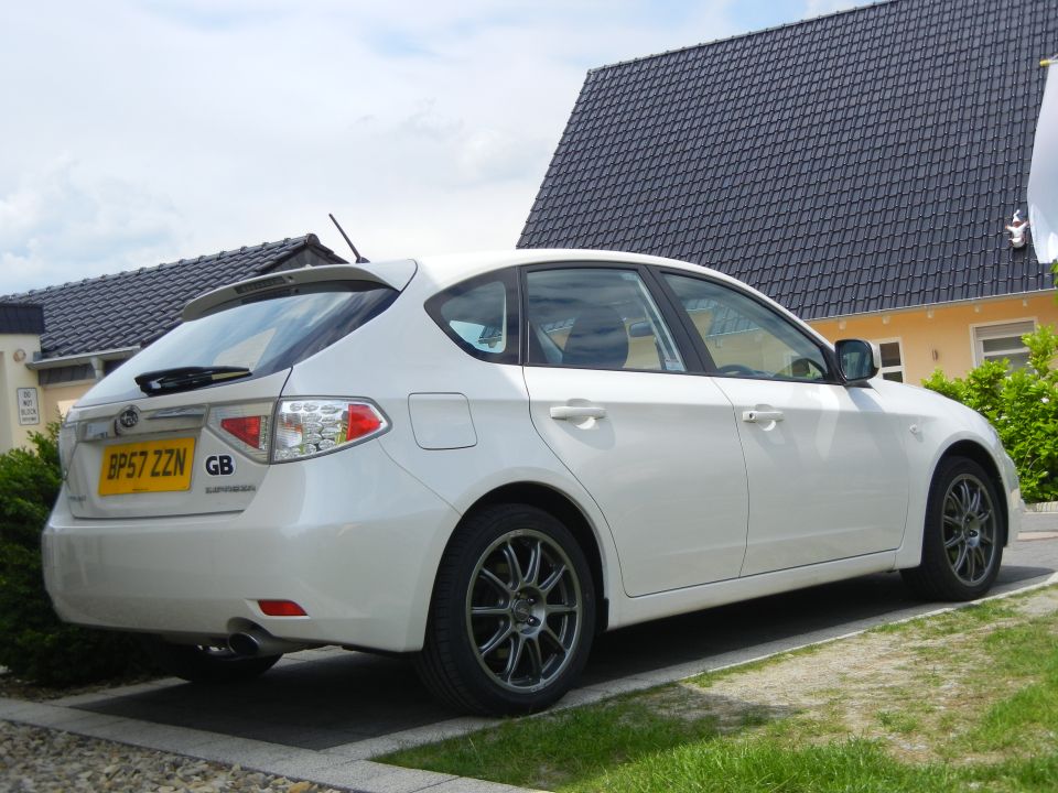 White Subaru hatchback parked in front of a house. License plate reads BP57 ZZN