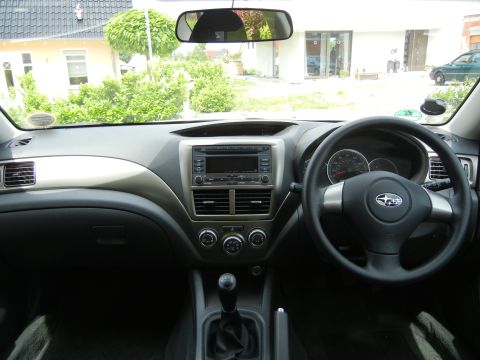 2008 Subaru Impreza - The interior of a Subaru Impreza shows the dashboard, steering wheel, and center console.