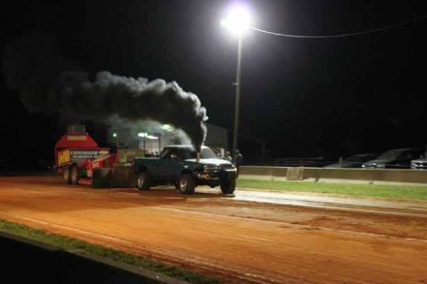 1997 Dodge 2500 - Truck pulling a sled at night, emitting a large cloud of black smoke.