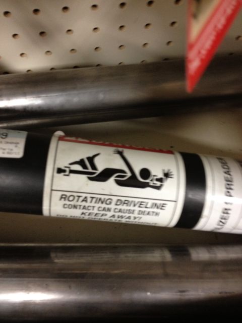 1986 Ford Bronco - This part has a warning label that says 'ROTATING DRIVELINE CONTACT CAN CAUSE DEATH KEEP AWAY!'