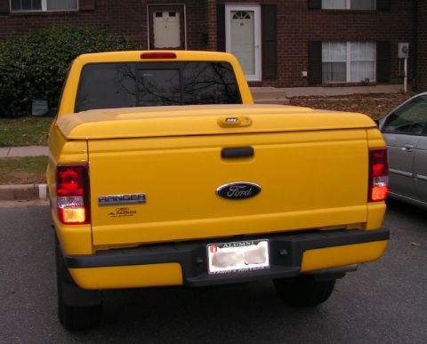 1999 Ford Ranger - Rear view of a yellow 1999 Ford Ranger pickup truck with a tonneau cover.
