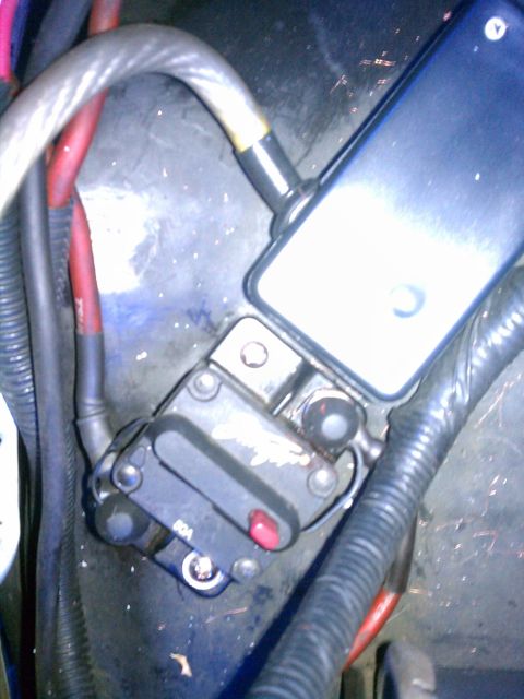 1993 Ford Bronco - Automotive circuit breaker with '80A' marking and red reset button.