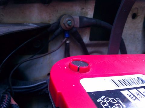 1993 Ford Bronco - The image shows a close-up view of a vehicle's battery terminals and associated wiring, focusing on the electrical connections.