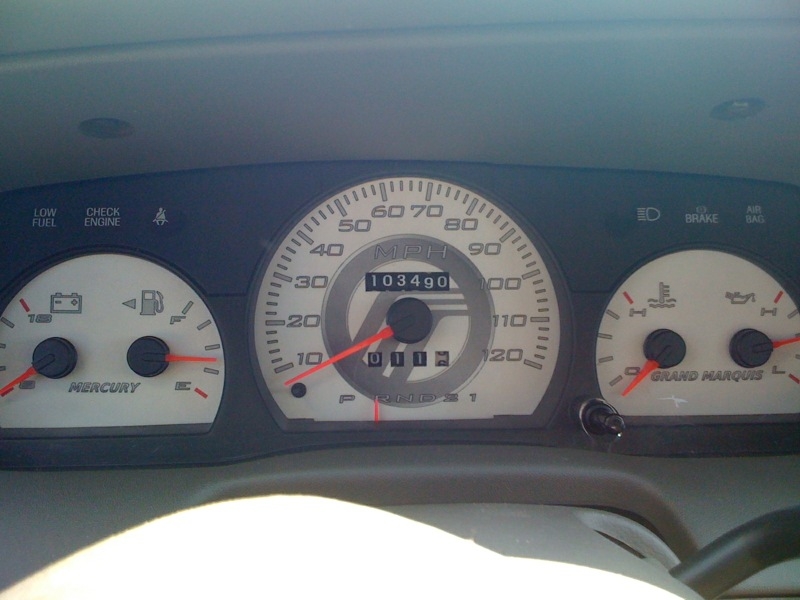 Mercury Grand Marquis gauge cluster in daylight showing 103490 miles